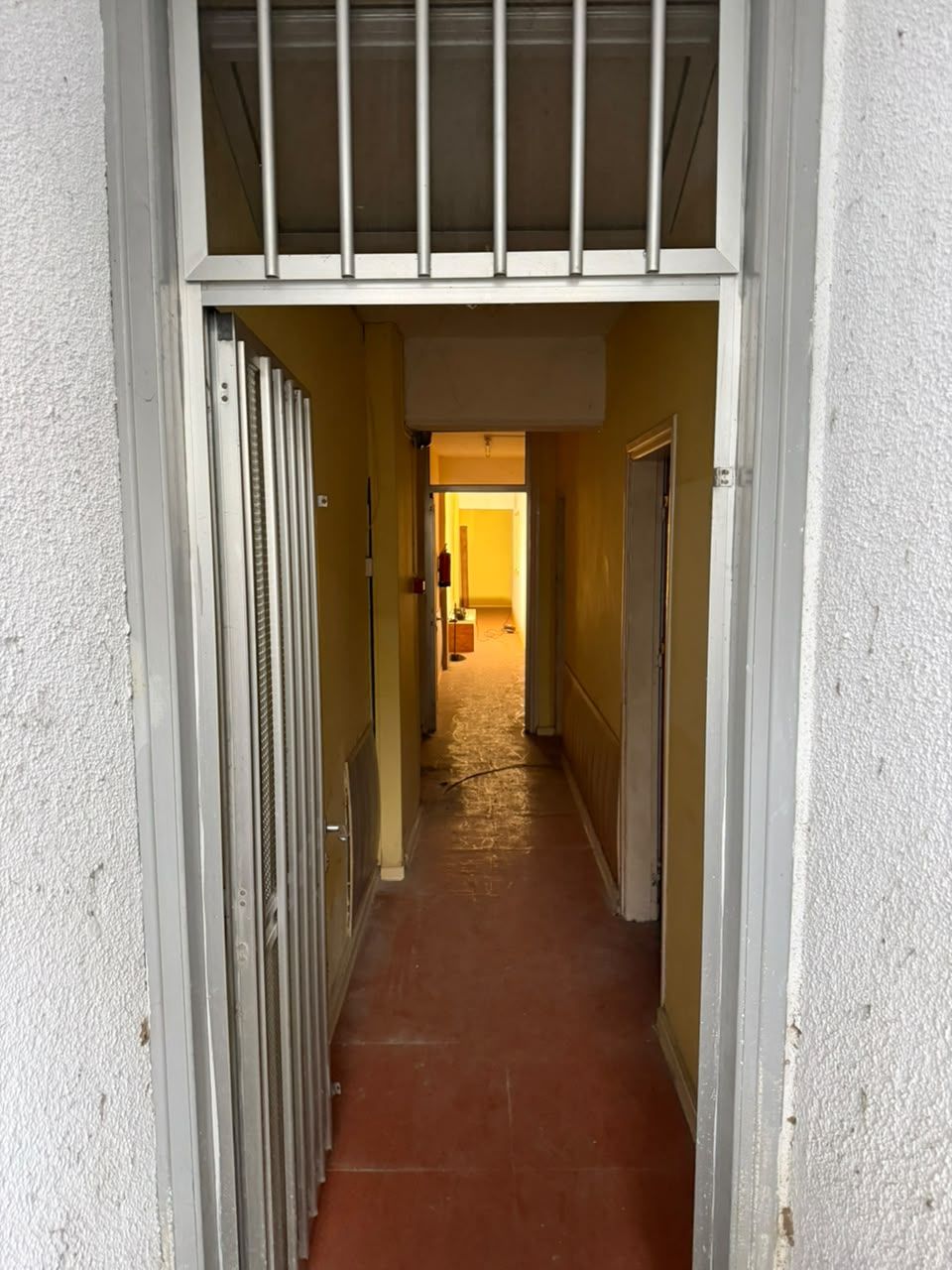 The entrance corridor of the new Apêiara space, seen through the open gate